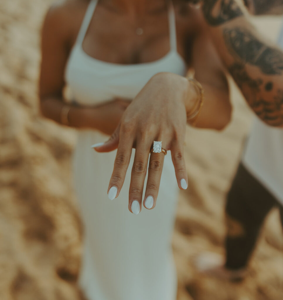 Man proposing to his girlfriend on the beach in Kauai