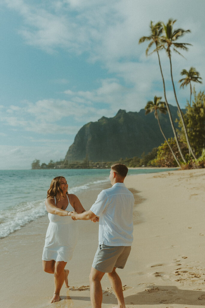 Candid photo of the newly engaged couple celebrating their Oahu proposal.
