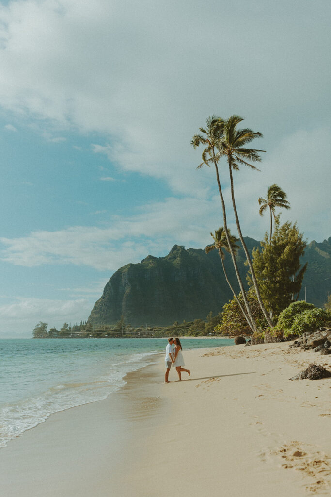 Candid photo of the newly engaged couple celebrating their Oahu proposal.
