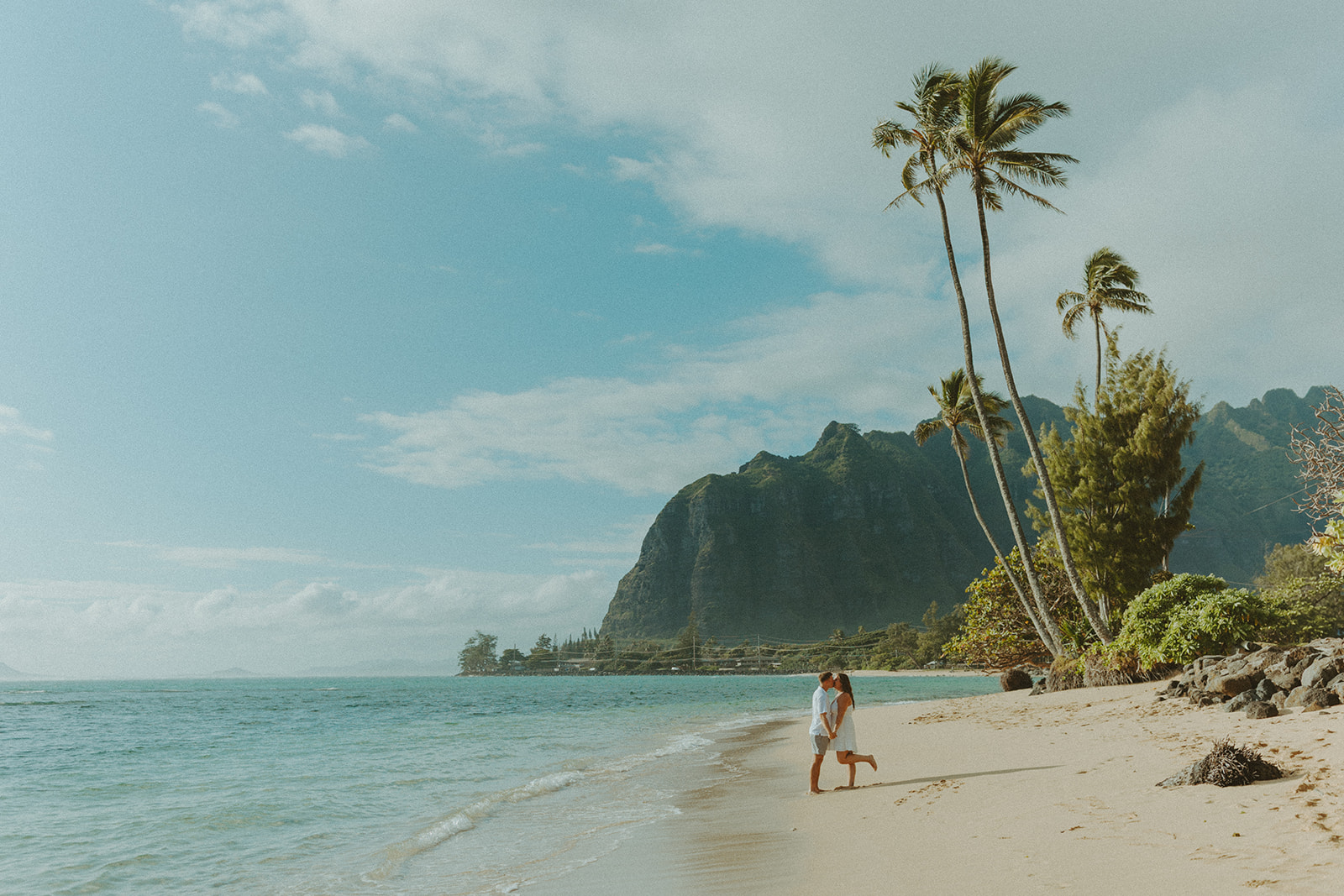 Nicole and Nicholas sharing a joyful moment after the surprise proposal in Oahu.