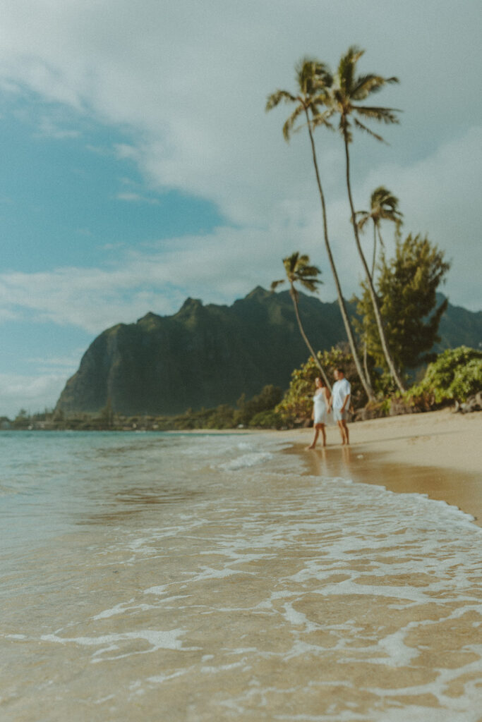 Candid photo of the newly engaged couple celebrating their Oahu proposal.
