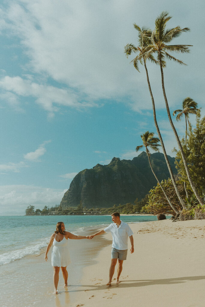 Candid photo of the newly engaged couple celebrating their Oahu proposal.
