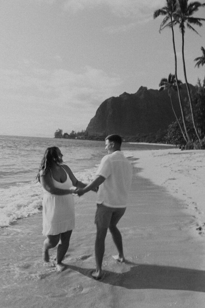 Candid photo of the newly engaged couple celebrating their Oahu proposal.
