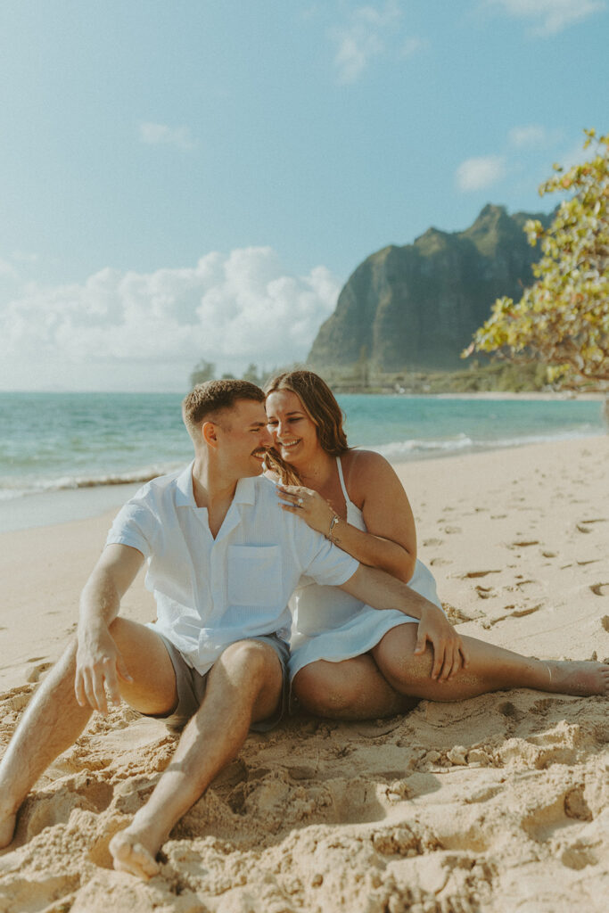 Nicole and Nicholas sharing a joyful moment after the surprise proposal in Oahu.