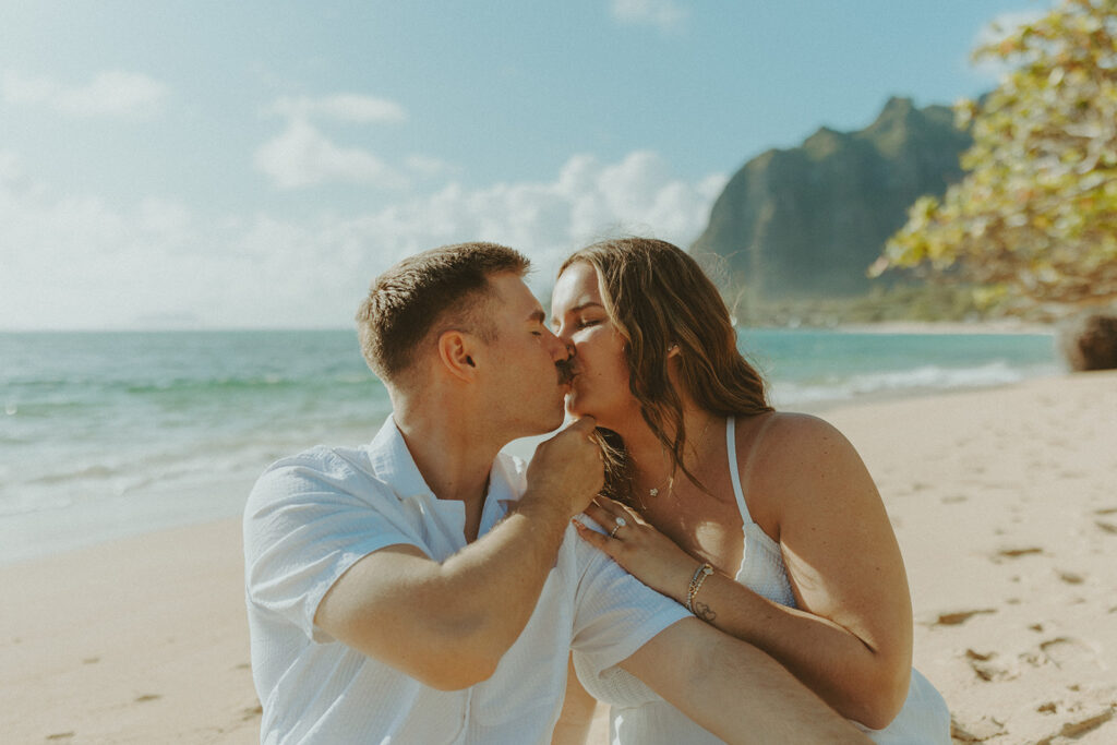 Candid photo of the newly engaged couple celebrating their Oahu proposal.
