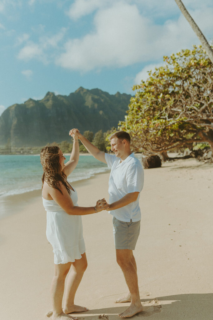 Candid photo of the newly engaged couple celebrating their Oahu proposal.
