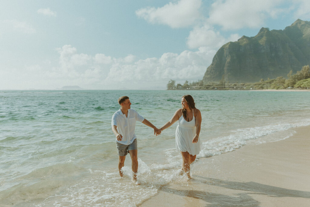 Candid photo of the newly engaged couple celebrating their Oahu proposal.
