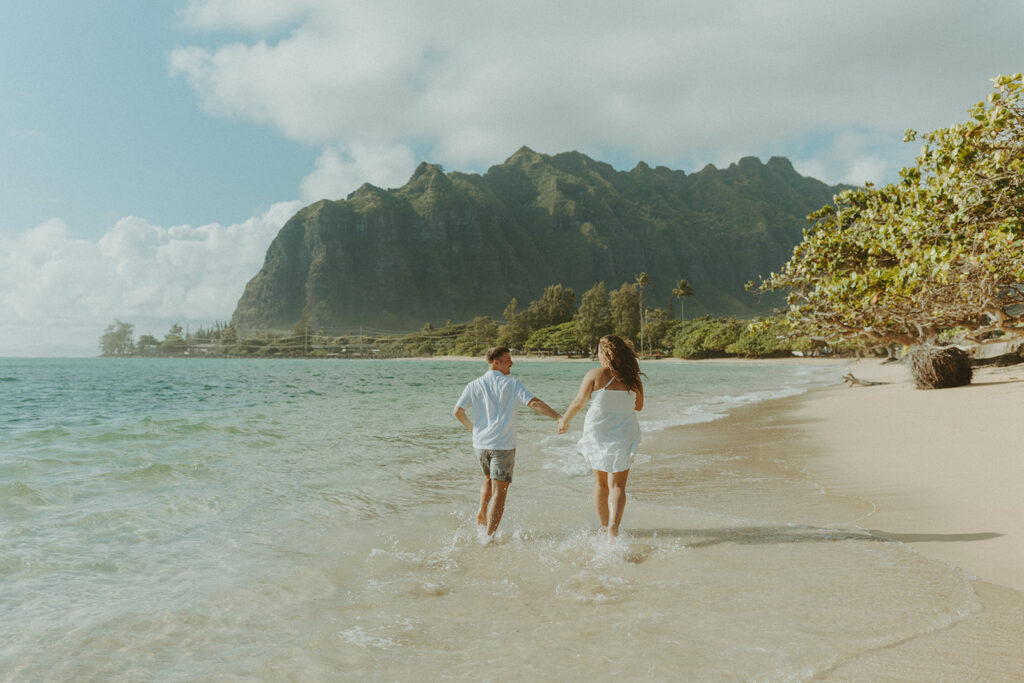 Candid photo of the newly engaged couple celebrating their Oahu proposal.
