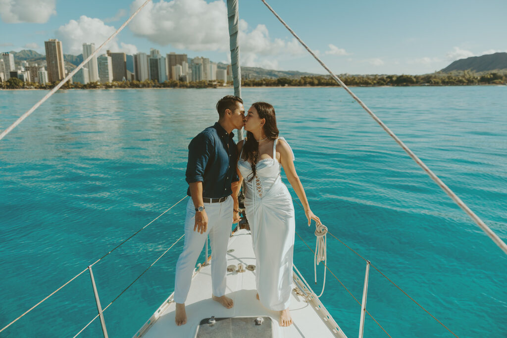 Intimate moment between couple captured during a dreamy sailboat engagement session
