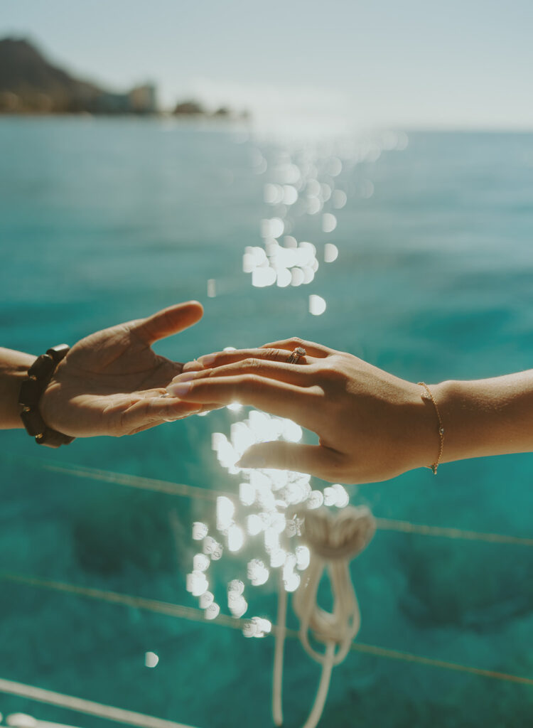 Intimate moment between couple captured during a dreamy sailboat engagement session
