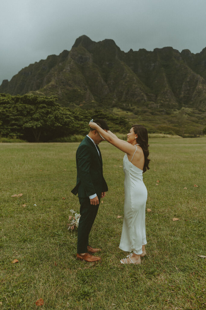 Elopement ceremony at Kualoa Regional Park with tropical floral details
