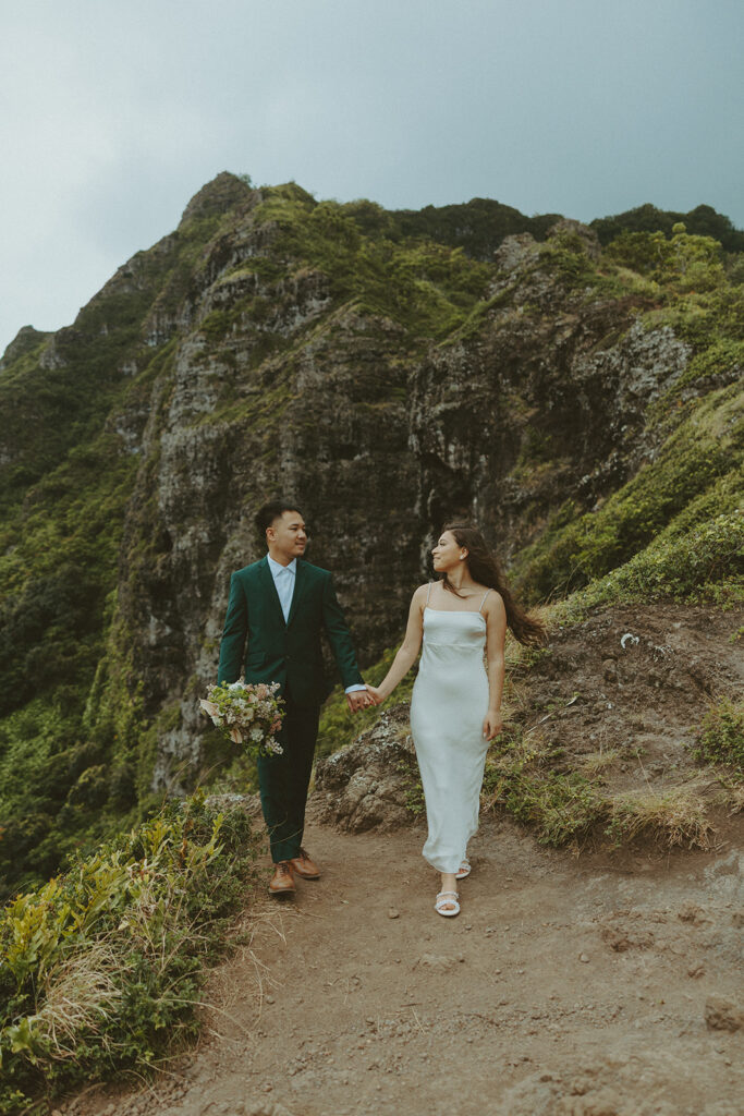 Elopement ceremony at Kualoa Regional Park with tropical floral details
