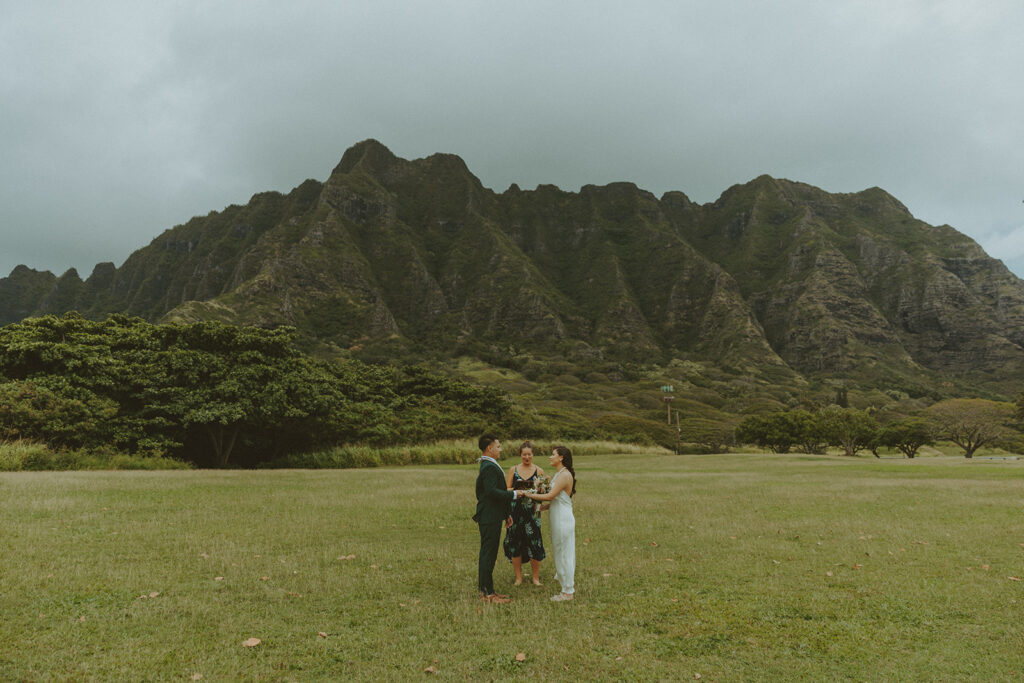 Elopement ceremony at Kualoa Regional Park with tropical floral details
