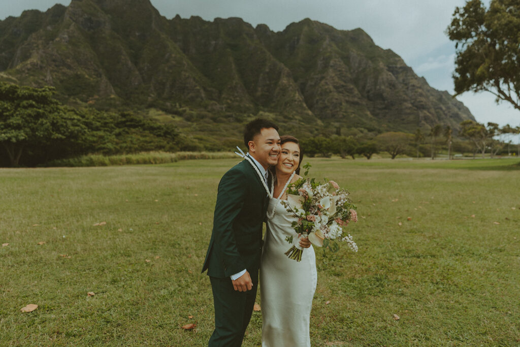 Elopement ceremony at Kualoa Regional Park with tropical floral details
