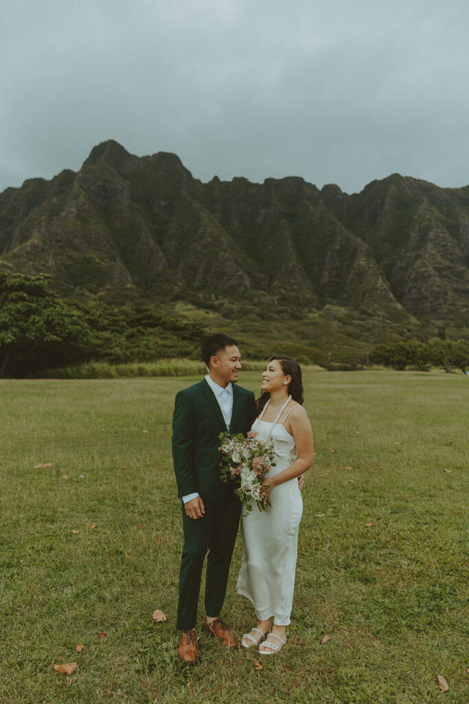 Elopement ceremony at Kualoa Regional Park with tropical floral details
