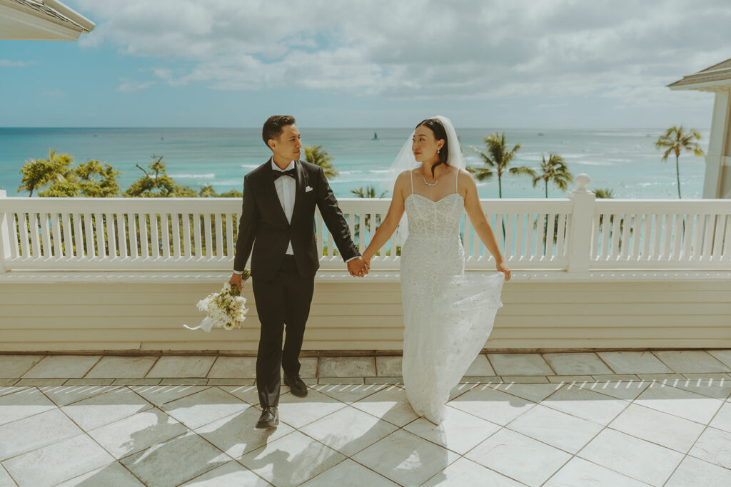 Groom and the bride on a terrace with ocean views at Moana Surfrider
