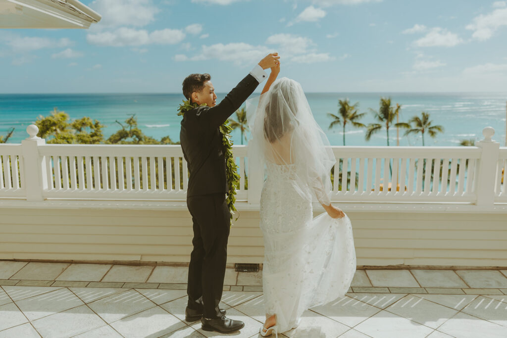 Groom and the bride on a terrace with ocean views at Moana Surfrider