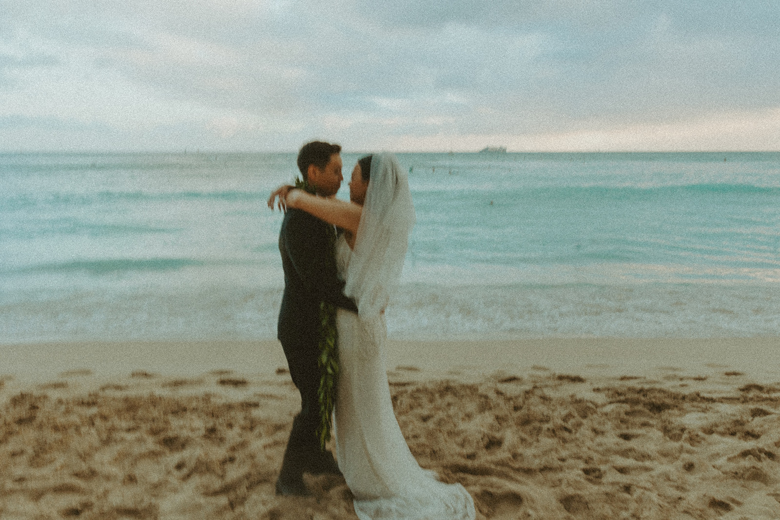 Bride and groom posing on the beach