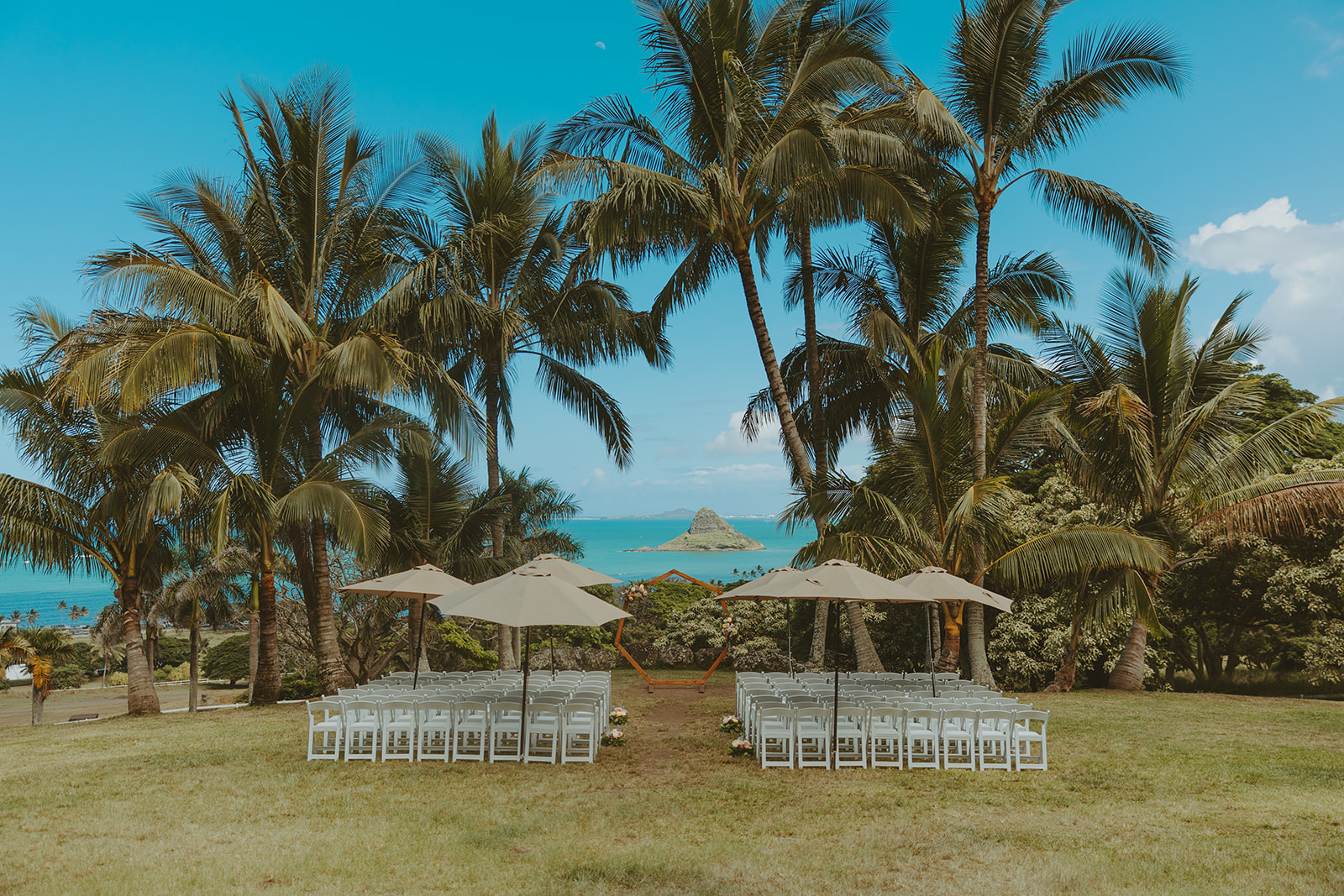 Wedding ceremony setup at Paliku Gardens surrounded by tropical greenery.