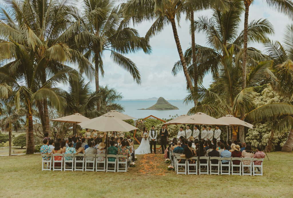 Wedding ceremony setup at Paliku Gardens surrounded by tropical greenery.
