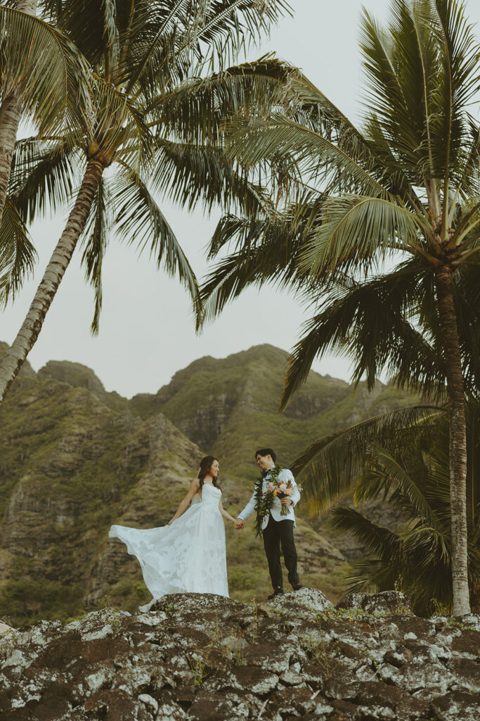 Bride and groom sharing a quiet moment during sunset portraits at Kualoa Ranch.
