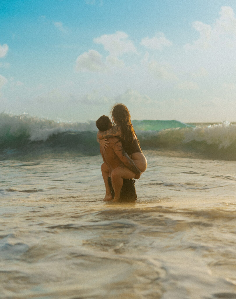 Intimate ocean photos of couple enjoying a Hawaii sunrise photoshoot
