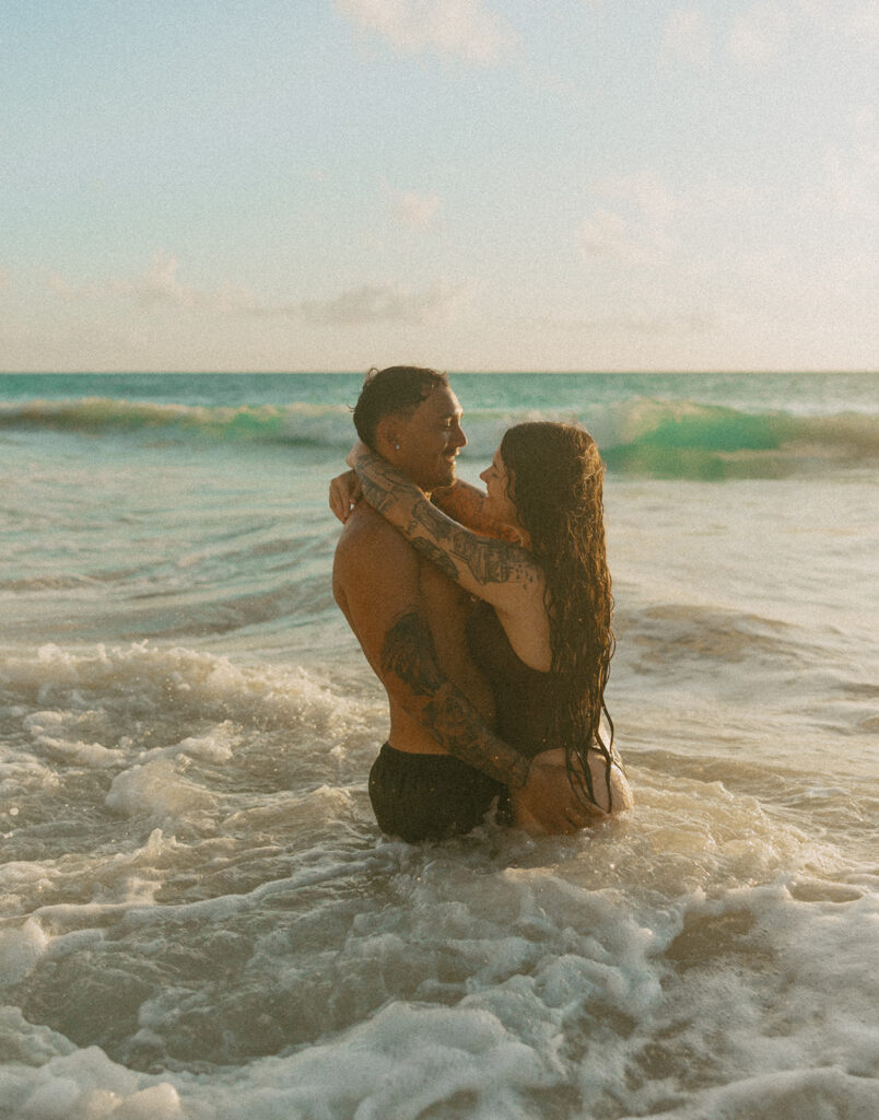 Intimate ocean photos of couple enjoying a Hawaii sunrise photoshoot
