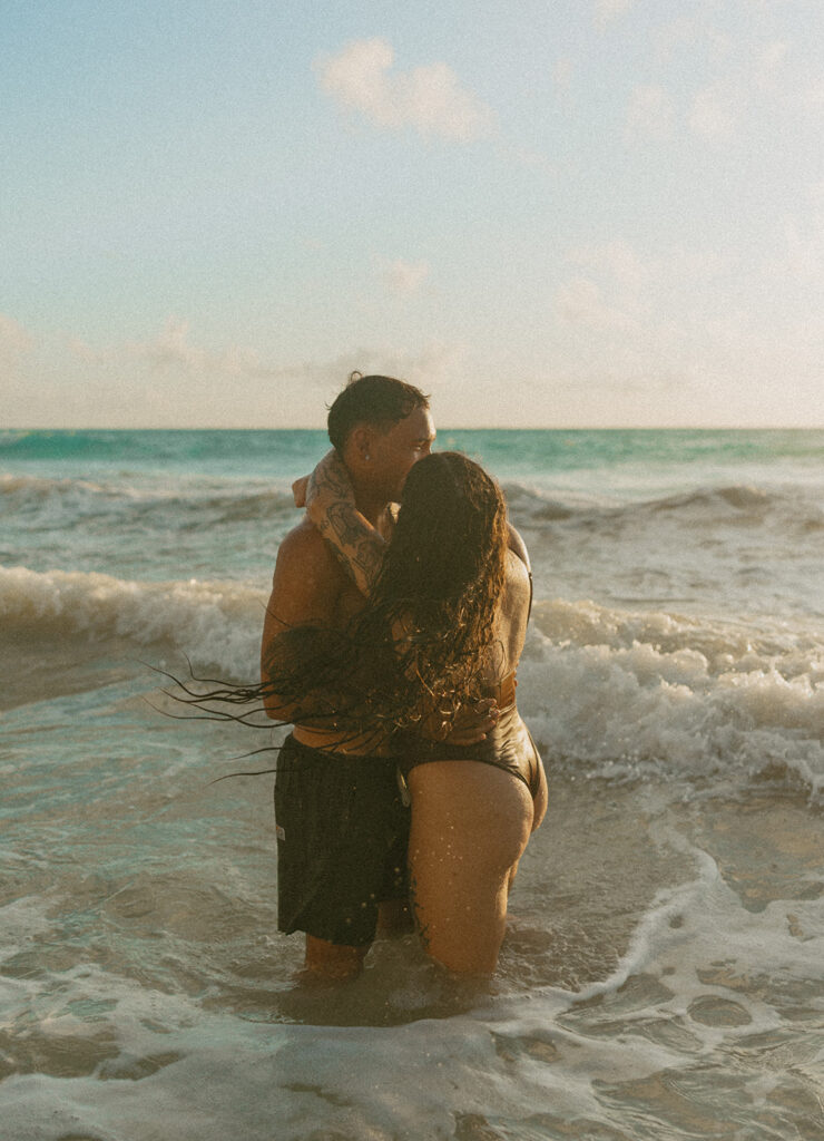 Intimate ocean photos of couple enjoying a Hawaii sunrise photoshoot
