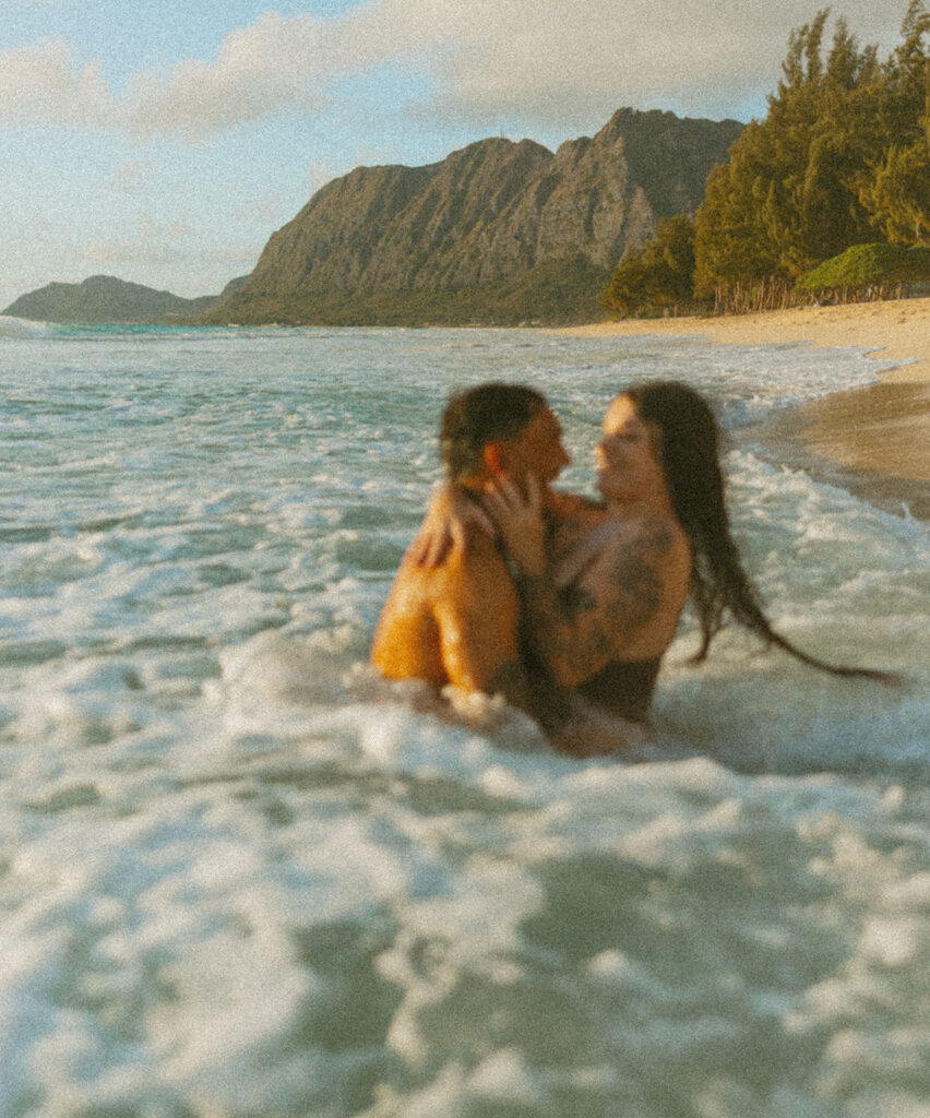Intimate ocean photos of couple enjoying a Hawaii sunrise photoshoot
