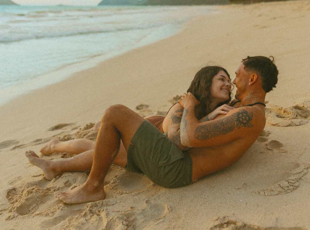 Couple holding hands and running along the beach during an Oahu couples photoshoot
