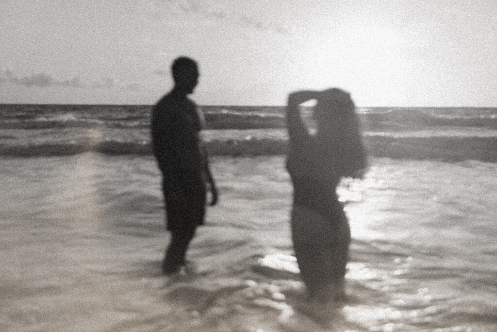 Playful couples session on the shore with golden morning light in Oahu
