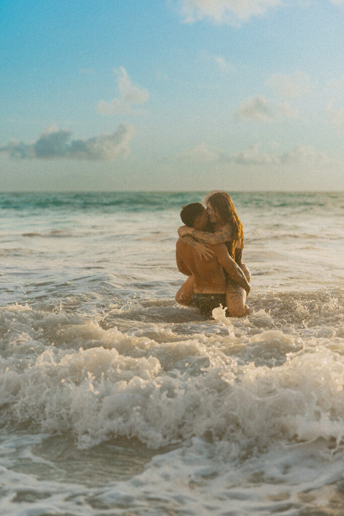 Intimate ocean photos of couple enjoying a Hawaii sunrise photoshoot
