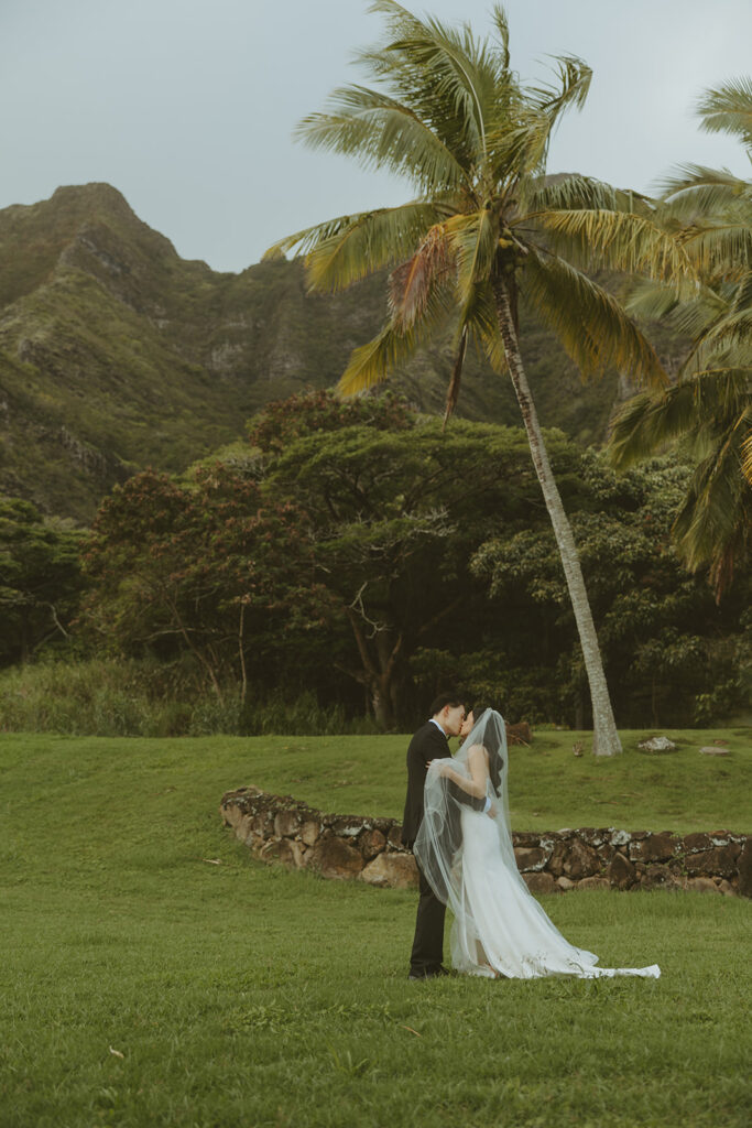 Bride and groom sharing a quiet moment during sunset portraits at Kualoa Ranch.

