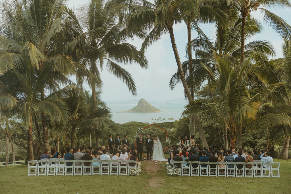 Wedding ceremony setup at Paliku Gardens surrounded by tropical greenery.

