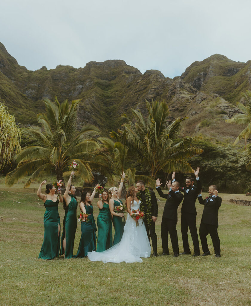 Guests enjoying a wedding reception under the trees at Paliku Gardens.
