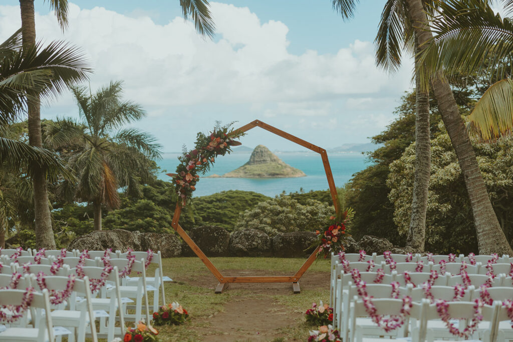 Wedding ceremony setup at Paliku Gardens surrounded by tropical greenery.
