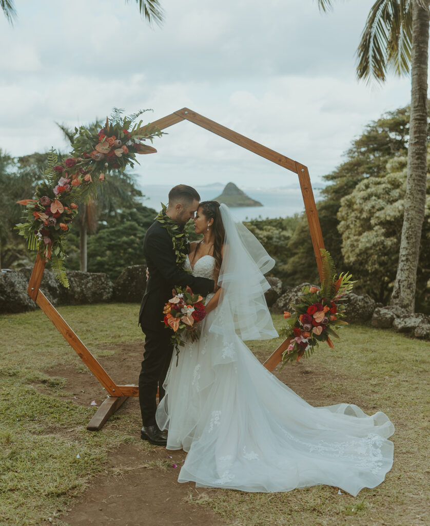 Wedding ceremony setup at Paliku Gardens surrounded by tropical greenery.
