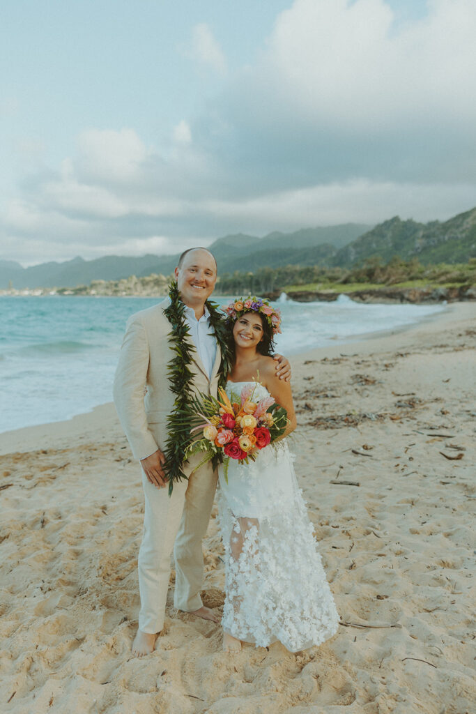Bride and groom celebrating with their wedding party along the ocean shoreline.
North Shore Elopement in Oahu