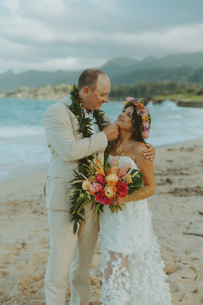 Romantic beach portraits of the couple surrounded by tropical scenery.

