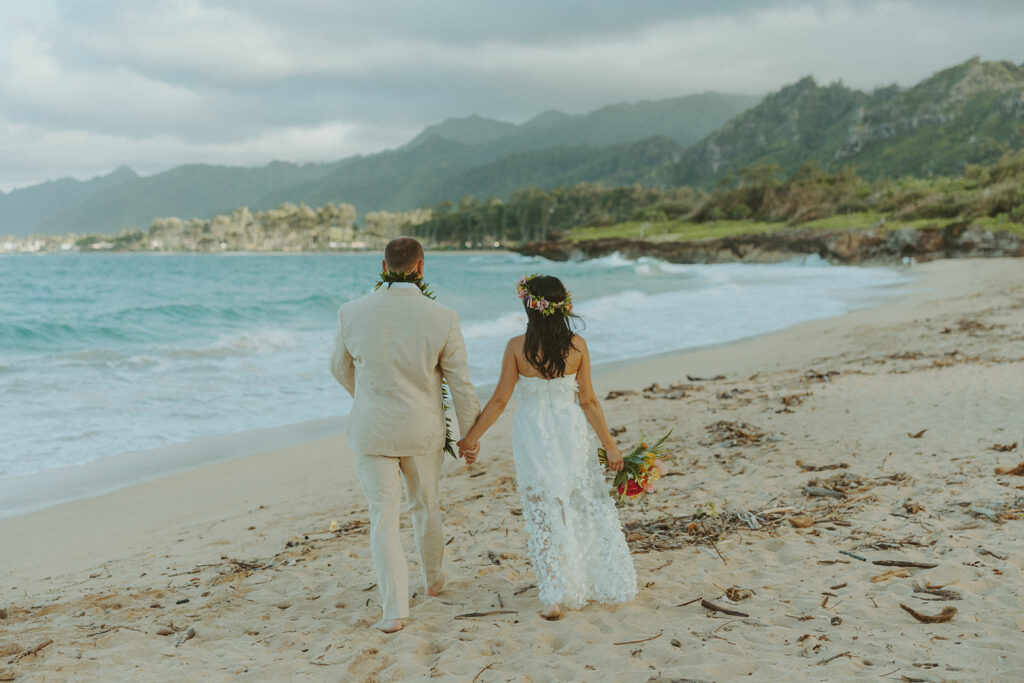 Romantic beach portraits of the couple surrounded by tropical scenery.
