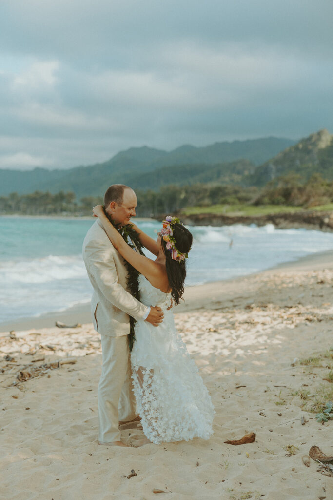 Romantic beach portraits of the couple surrounded by tropical scenery.
