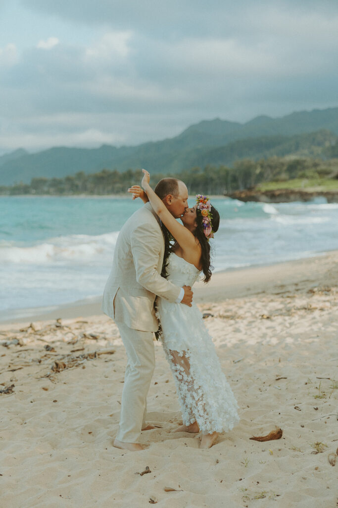 Romantic beach portraits of the couple surrounded by tropical scenery.
