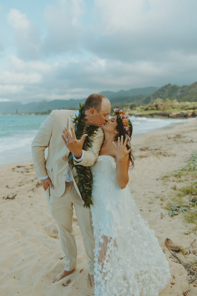 Couple exchanging vows during an intimate North Shore elopement ceremony on the beach.
