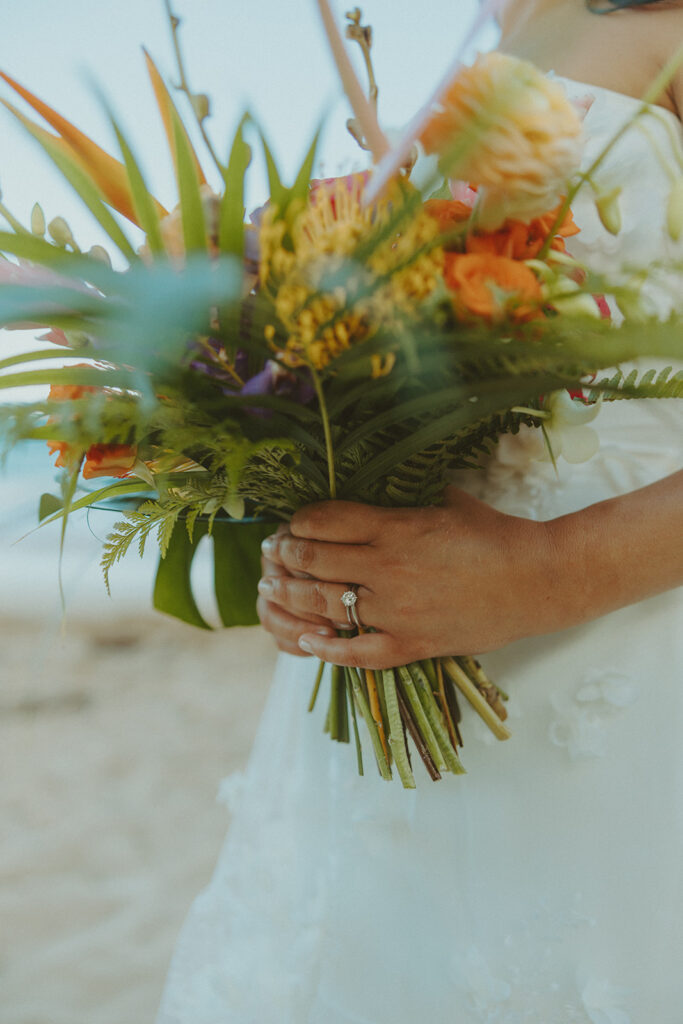 Romantic beach portraits of the couple surrounded by tropical scenery.
