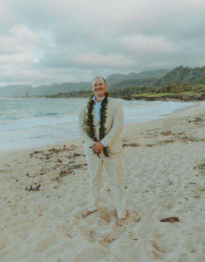 Romantic beach portraits of the couple surrounded by tropical scenery.
