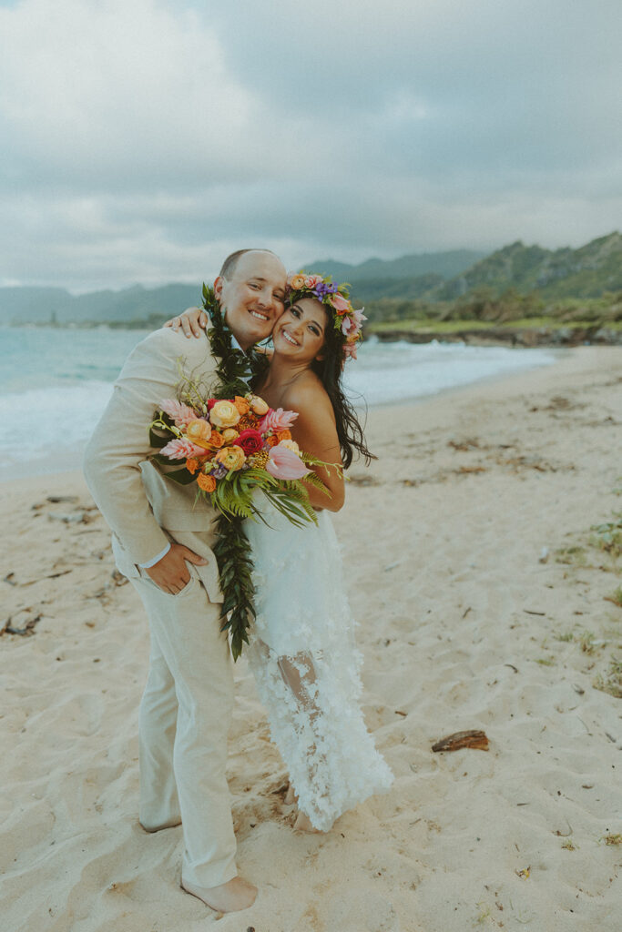 Romantic beach portraits of the couple surrounded by tropical scenery.
