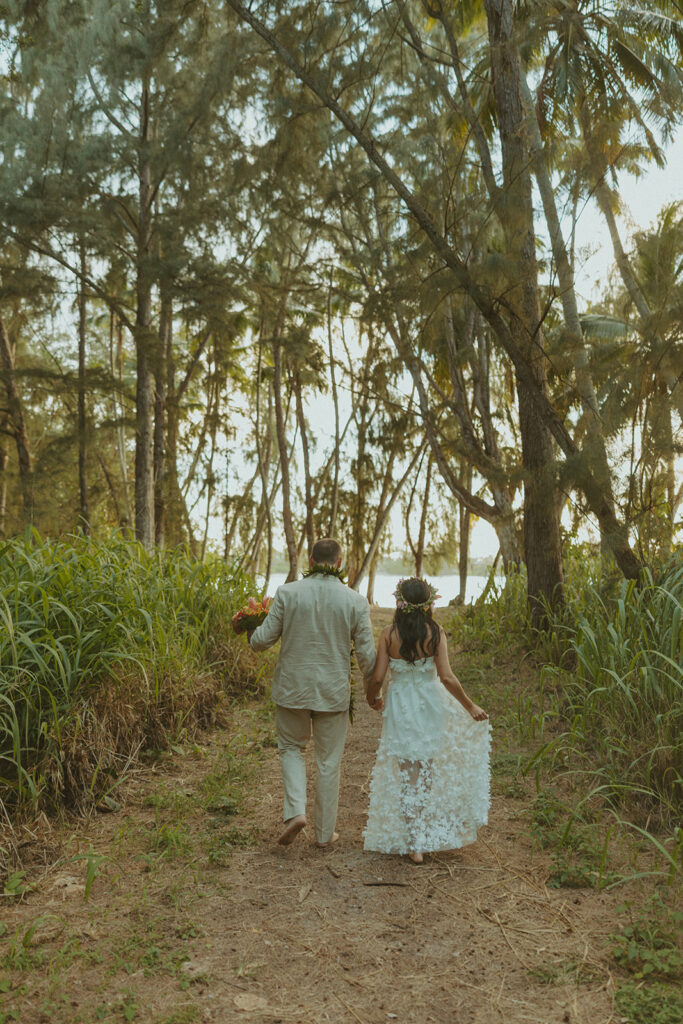 Newlyweds exploring a lush jungle location near Turtle Bay Resort after their ceremony.

