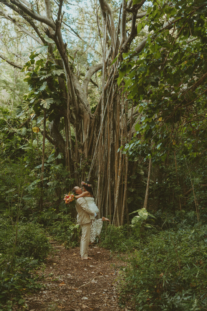 Newlyweds exploring a lush jungle location near Turtle Bay Resort after their ceremony.
