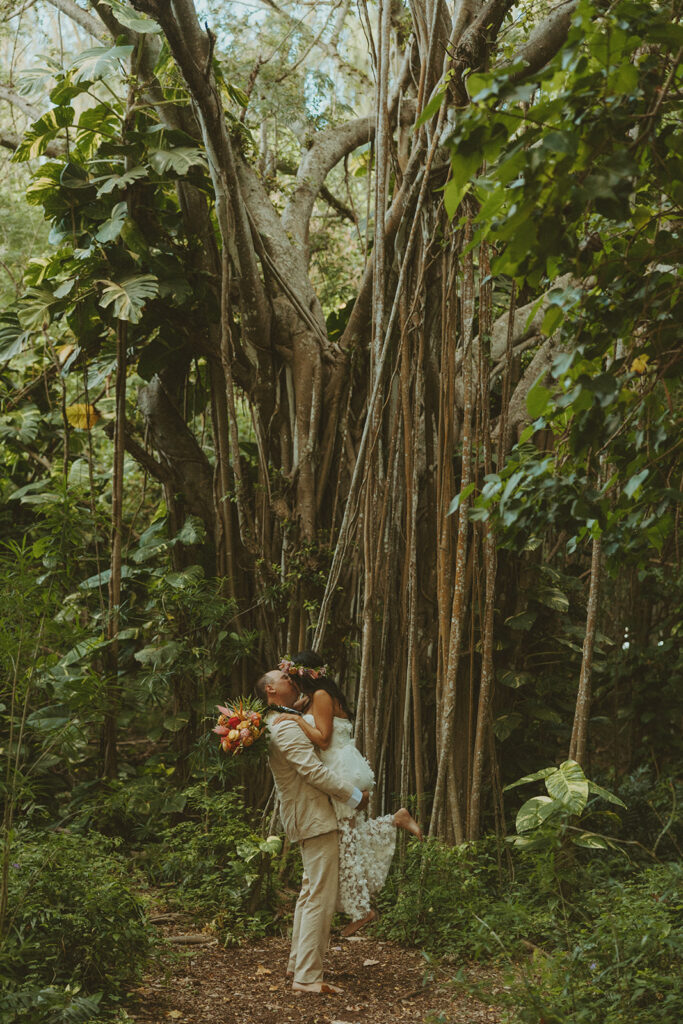 Newlyweds exploring a lush jungle location near Turtle Bay Resort after their ceremony.
