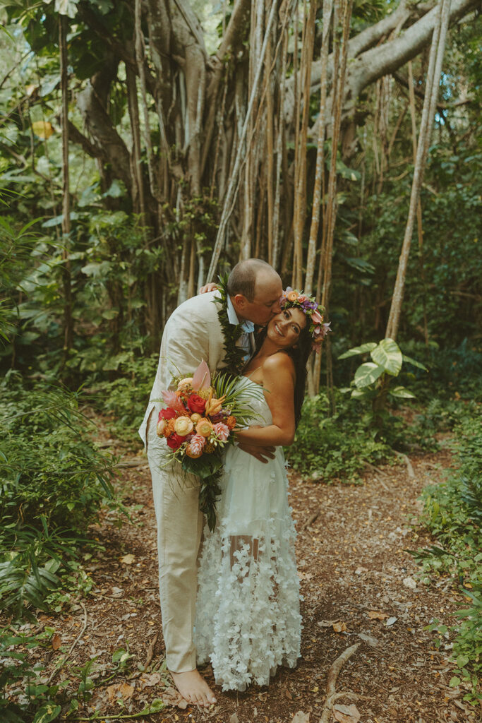 Newlyweds exploring a lush jungle location near Turtle Bay Resort after their ceremony.
